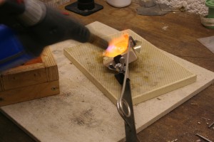 gently rock the crucible side to side to help melting the silver