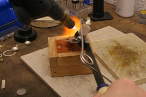 pouring the molten silver into the mold